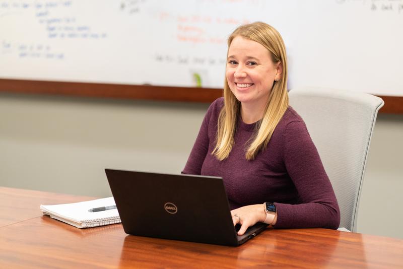 Woman sitting at table with laptop